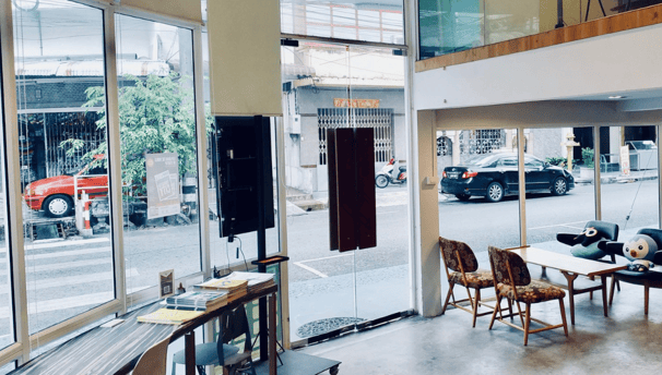 a room with a table and chairs and a television