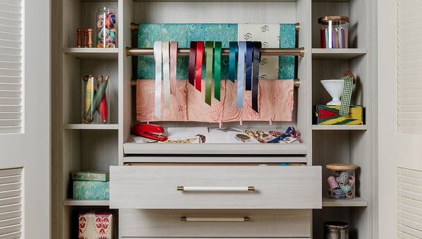a closet with a shelf full of books and a toy