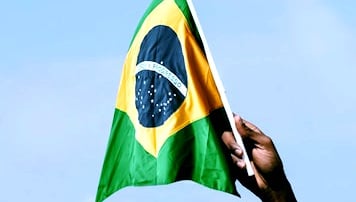 a man holding a flag in front of a building