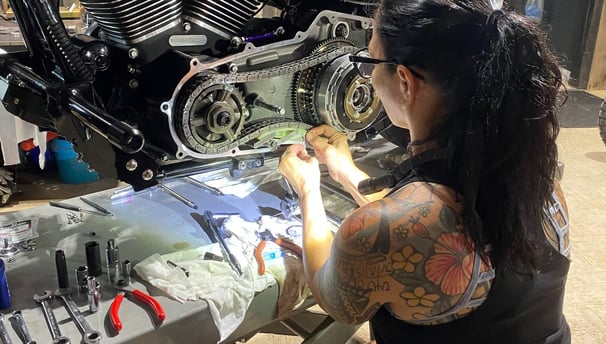 woman working on motorcycle