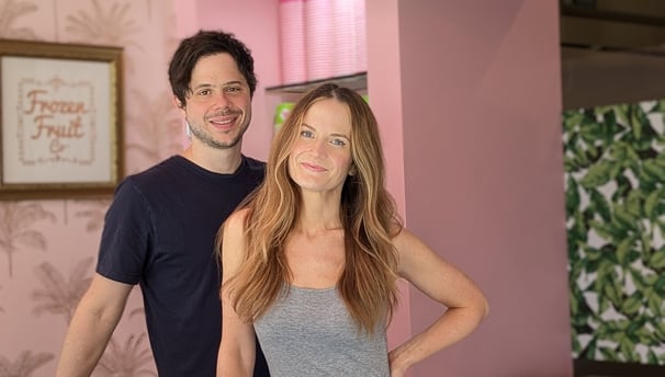 a man and woman standing in front of a counter
