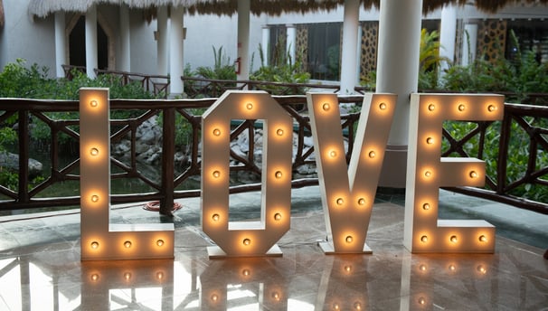 a large light up letters spelling love in front of a house