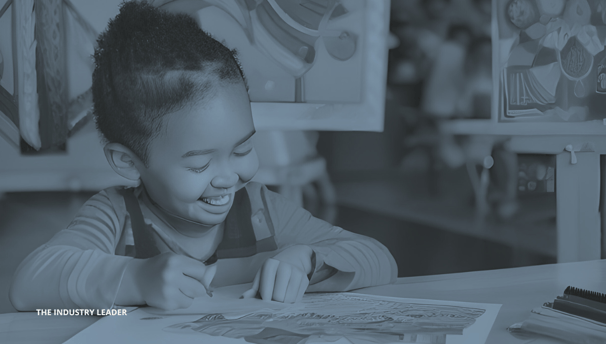 a young child is smiling and holding a coloring book