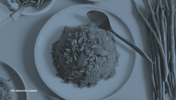 a plate of rice with a spoon and spoons