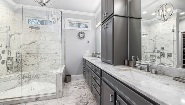 a bathroom with a marbled counter top and a shower