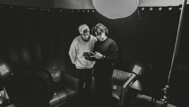 Two men setting up a podcast studio in Dallas.