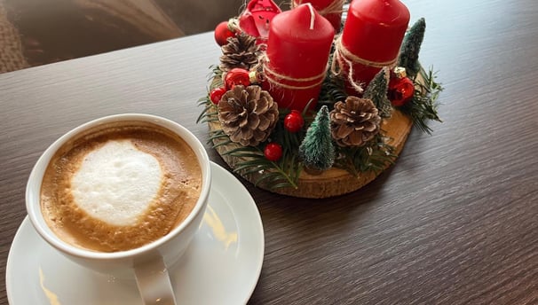 a cup of coffee with a candle on a table