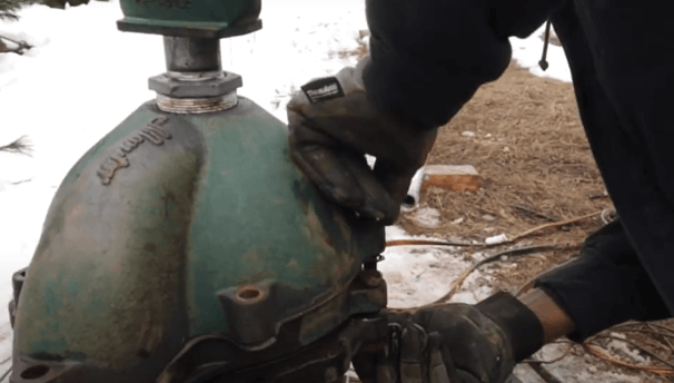 Technician installing well head