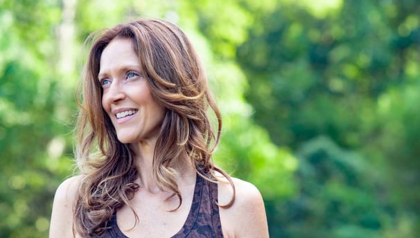 a woman with a brown tank top and a black tank top