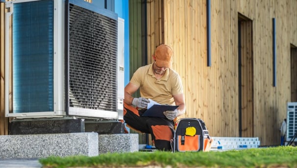 a man sitting on a bench reading a book