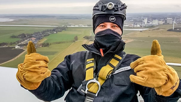 a man in a helmet and safety gear on a rope
