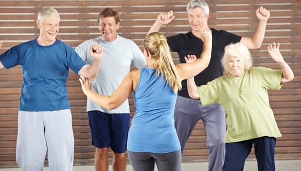 a group of older people doing a dance routine