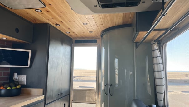 Vintage RV parked at beach enjoying view from stunning inside transformation