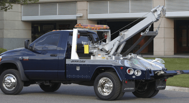 A blue tow truck with silver equipment