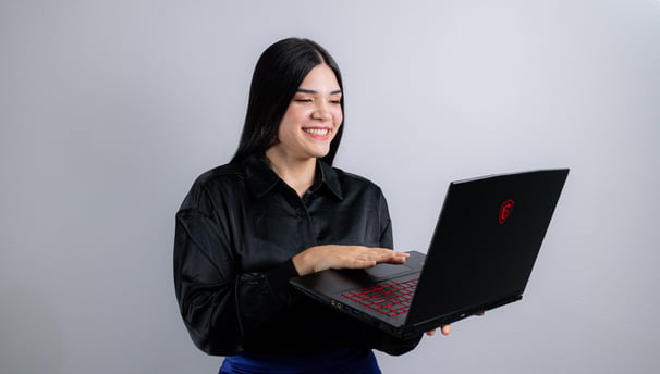 a woman in a black shirt and blue skirt