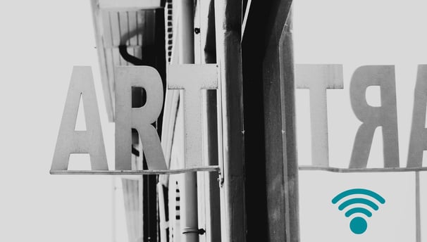 Black and white photograph of a shopfront sign reading "ART", symbolising Martin Osner’s curated online gallery for fine art 