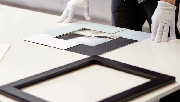 Professional artwork framing in progress at Osner Framing Studio, using archival materials.
