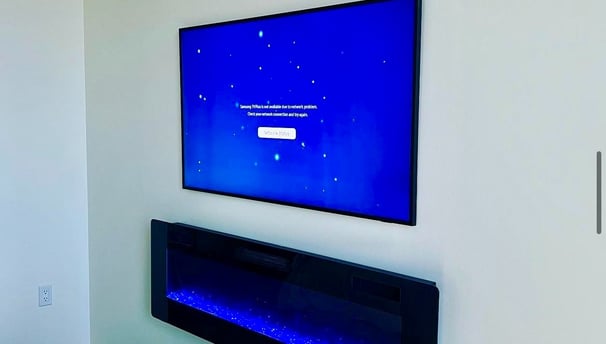 TV mounted with a electric fire place.