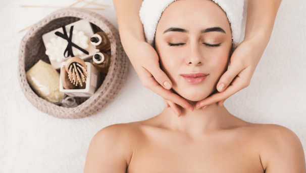 a woman getting a facial massage at a spa