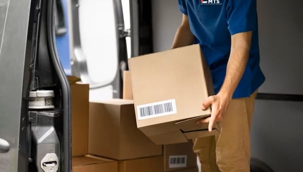MTS driver loading boxes carefully ready for next day delivery