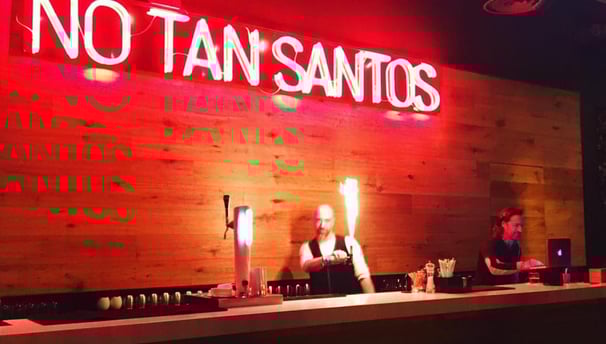 a bar with a neon sign that says no tan's on it
