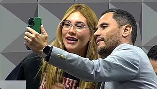 a man and woman taking a selfie with a green phone