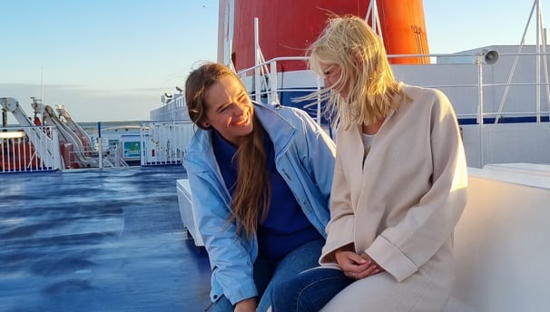 Two friends enjoying each other's company on a ferry to Sweden.