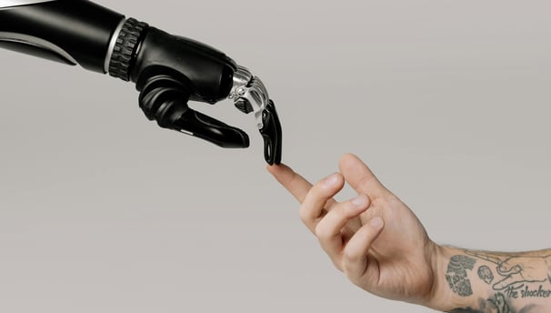 a person holding a black and white robotic hand
