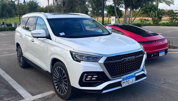 a white suv parked in a parking lot