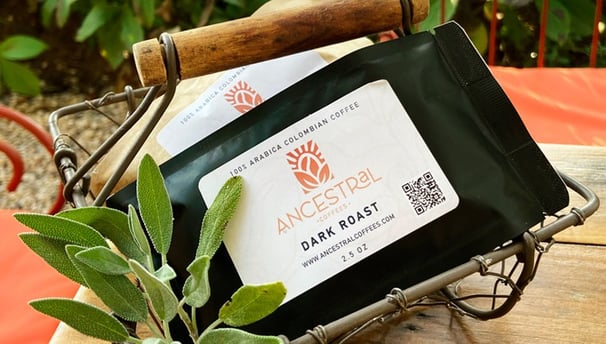 Bags of Ancestral Coffees showcasing medium and dark roast Colombian coffee