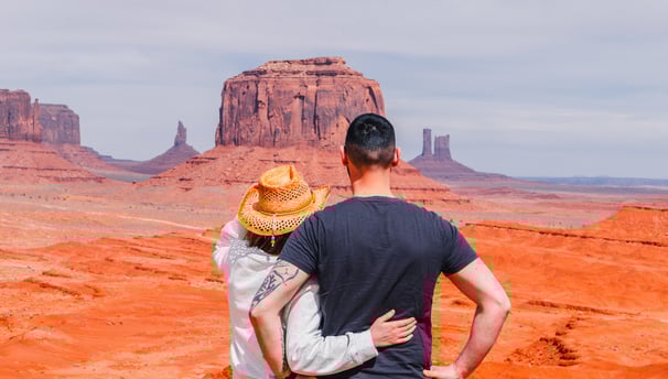 a man and woman standing in the desert
