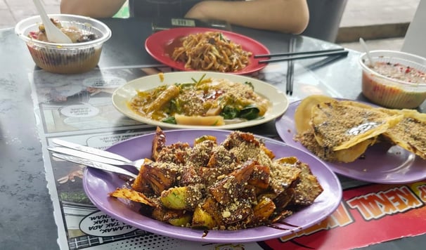 rojak, cucumber, fried tofu and pineapple tossed in a dark sticky sweet and spicy sauce 