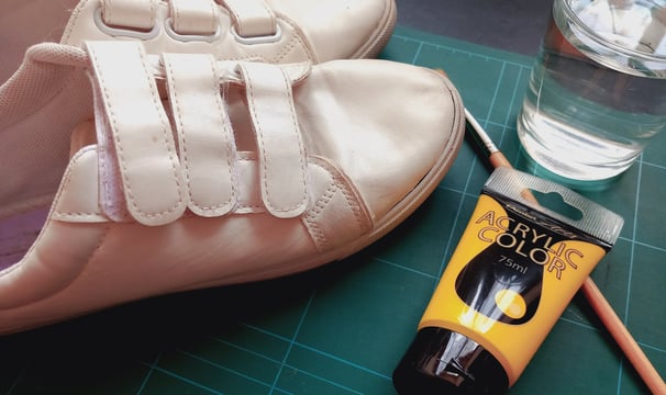 a pair of shoes and a brush on a table