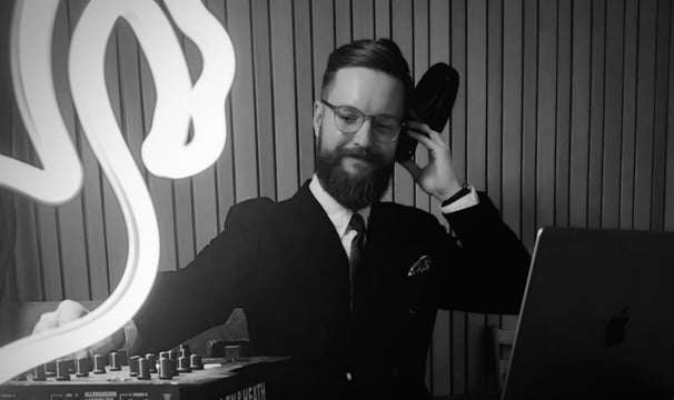a man in a suit and tie. DJ.