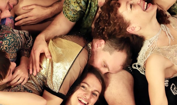 a group of people laying on the floor in a cuddle puddle
