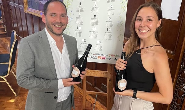 Alex Duffy and Nicola Lashley holding bottles of Prosecco.