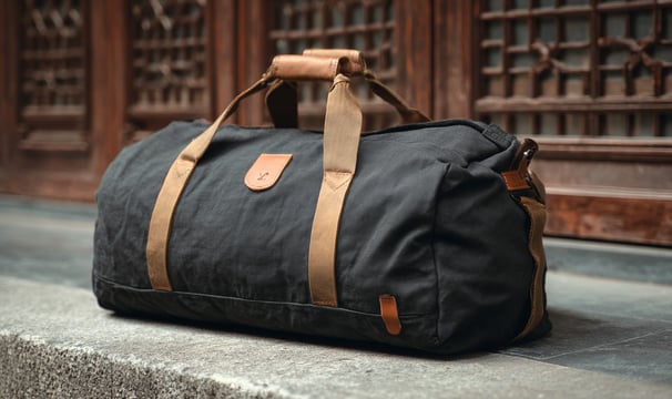 Duffel bag with shoe pocket and mesh panel