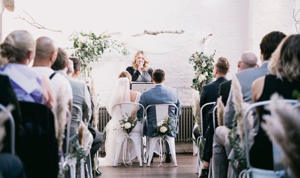 a bride and groom are sitting at the altar