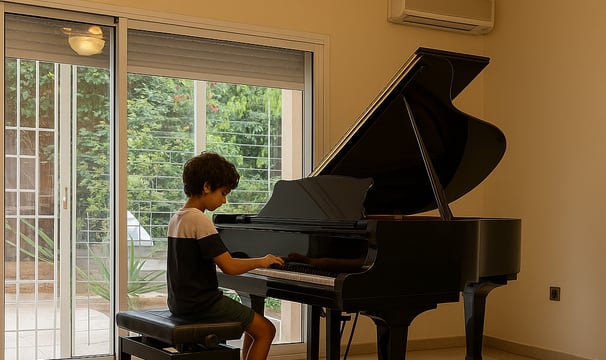 a young boy playing a piano in a living room