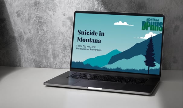 a laptop computer sitting on a table with a mountain view