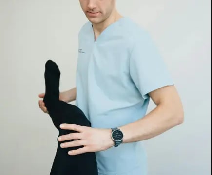 A physiotherapist with his patient