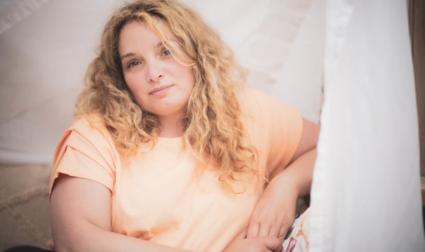 a woman with blonde hair and a pink shirt
