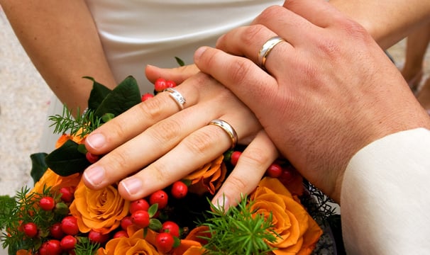 Hands holding with wedding rings