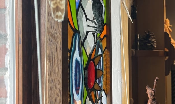 brass insects added to stained glass art