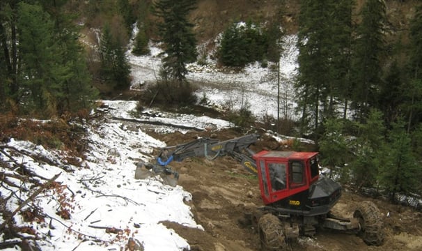 Spider doing erosion repairs on steep fireguard in okanagan valley