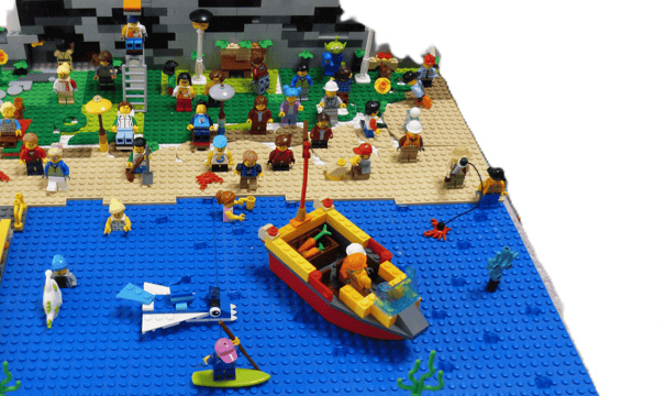 Construcción de una playa con todos los personajes que están en ella, al fondo construcción rocosa  