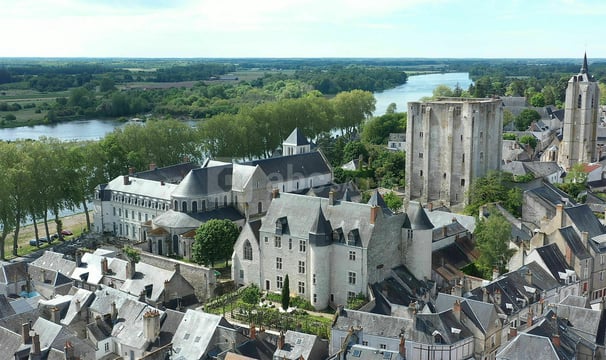 beaugency a large building with a tower in the middle of it