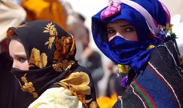 a woman in a blue scarf and a man in a black suit