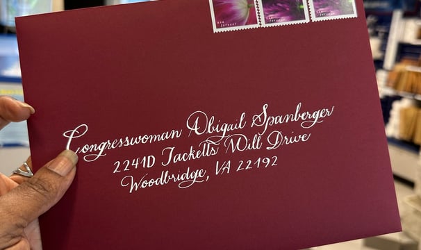 Custom calligraphy on burgundy envelope