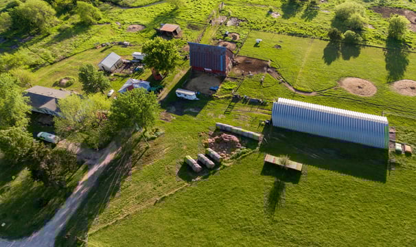 a farm with a barn and a barn in the background